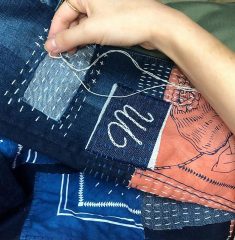 Heavily patched jeans with sashiko stitches.